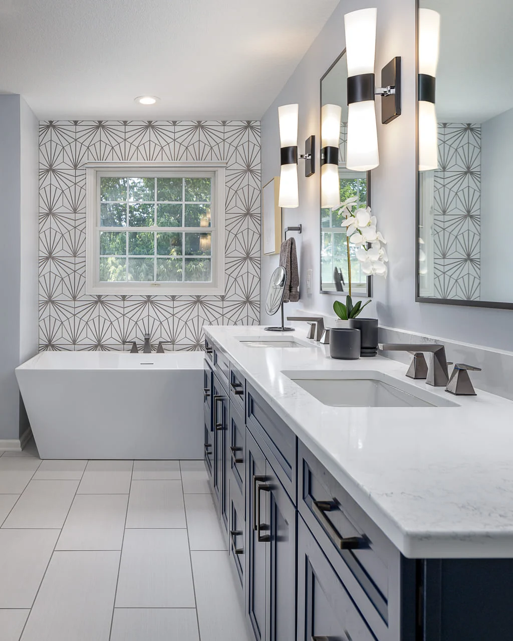 Art Deco Inspired Modern Bathroom with Double Sinks and Eye-Catching Wallpaper Behind Standalone Tub _ Compelling Homes